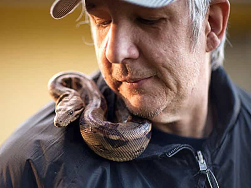 Man with a snake on his shoulder